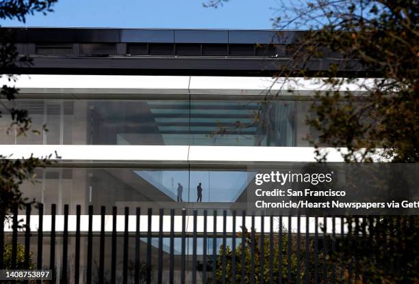 An employee walks through the headquarters building at Apple Park in Cupertino, Calif. On Tuesday, Feb. 20, 2018.