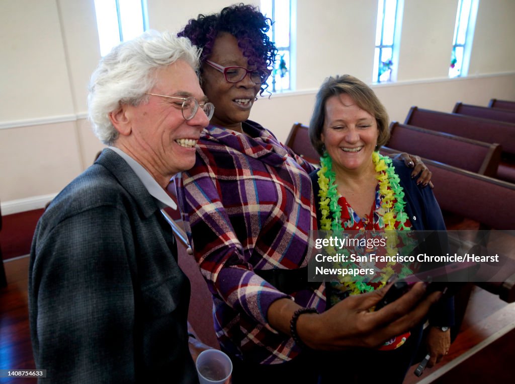 Chuck Poling, Souriya Johnson and Denise Bailey gather for a group selfie at a reunion of the Woodrow Wilson High School gospel choirs from the 1970's at Olivet Baptist Church in San Francisco, Calif. on Saturday, June 3, 2017