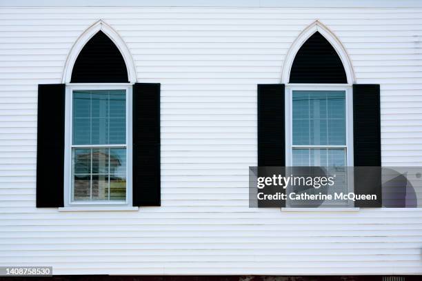 side view of white clapboard church in quaint new england town - black window shutters stock pictures, royalty-free photos & images