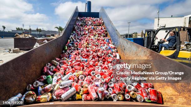 July 14: Aluminum cans move up a conveyor at OCC Recycling Center in Costa Mesa, CA on Thursday, July 14, 2022. The cans will be compressed into an...