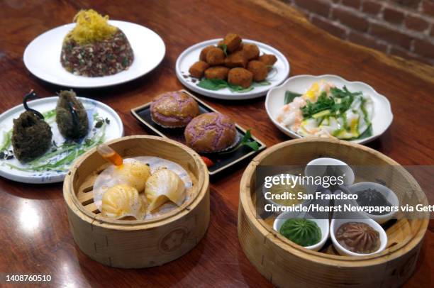 Clockwise from top left, vegetarian fried red wild rice, seven spice crispy silk tofu, rainbow prawns rice crepe, Palette xiao long bao, lobster ha...