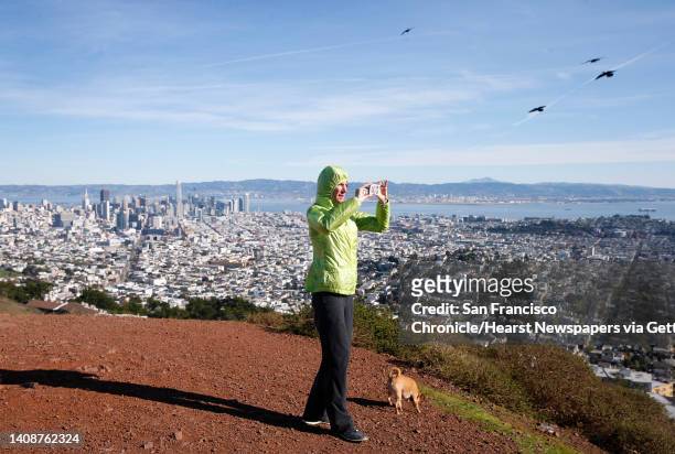 Catherine Vowles captures a 360-degree panoramic photo after climbing to the south summit of Twin Peaks with her dog Bandito in San Francisco, Calif....
