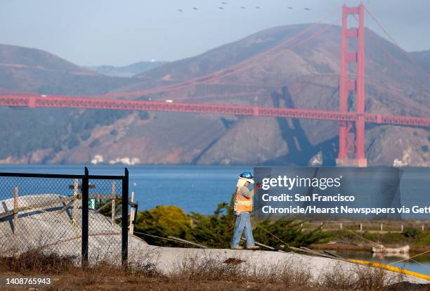 Construction worker stands on the roof of the northbound main post tunnel while work continues on the Presidio Tunnel Tops landscaping project in San...