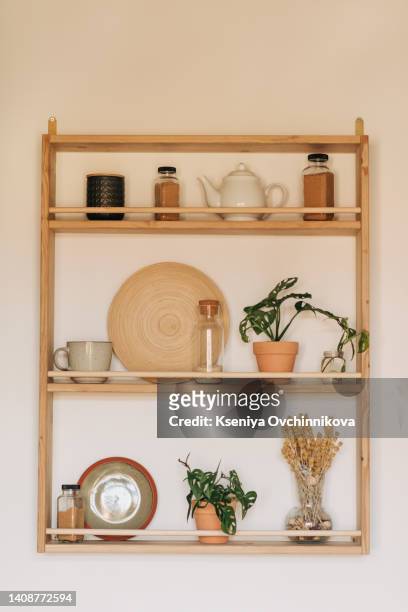 stylish scandinavian open space with kitchen accessories, plants and sofa. design room with white walls. - wood ledge stock pictures, royalty-free photos & images