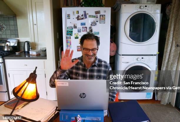 Will Cautero waves to Las Lomas High School students as they log in for an 11th grade English class conducted remotely from his home in Oakland,...