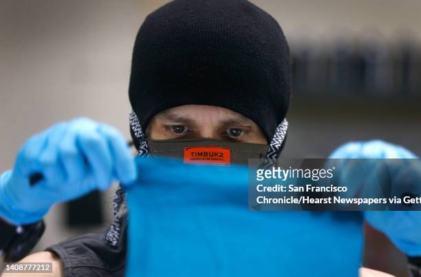 Micah Cash sews a face mask using a San Jose Sharks t-shirt at the Timbuk2 factory in San Francisco, Calif. On Tuesday, April 21, 2020. Timbuk2 is...