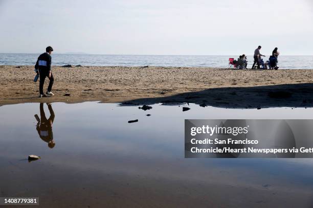 Visitors gather at Drakes Beach in Point Reyes National Seashore on Wednesday, Dec. 23, 2020. Drakes Beach is a popular spot for whale watching.