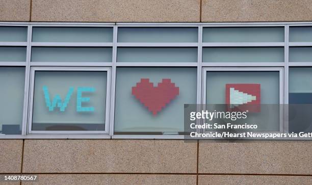Employees of a Walmart corporate office building post a message for employees of YouTube headquarters located across the street in San Bruno, Calif....