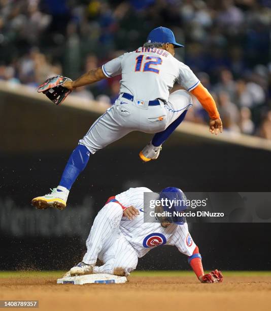 Francisco Lindor of the New York Mets throws to first as Christopher Morel of the Chicago Cubs is out on a double play during the fifth inning of a...