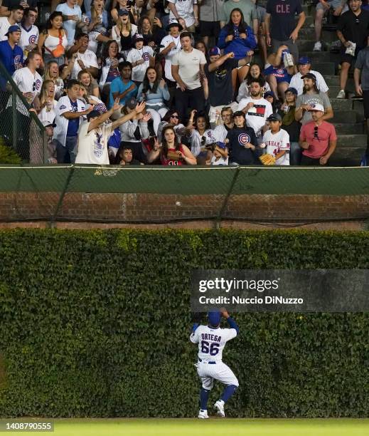 Rafael Ortega of the Chicago Cubs is unable to catch the home run by Brandon Nimmo of the New York Mets during the sixth inning of a game at Wrigley...