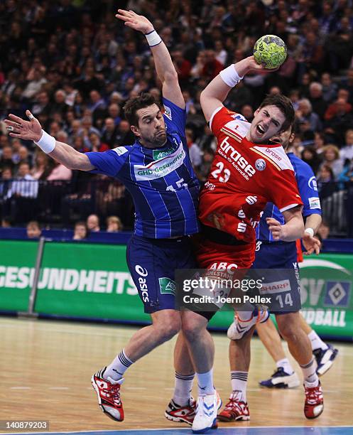 Hendrik Pekeler of Bergischer HC is challenged by Guillaume Gille of Hamburg during the Toyota Bundesliga handball game between HSV Hamburg and...