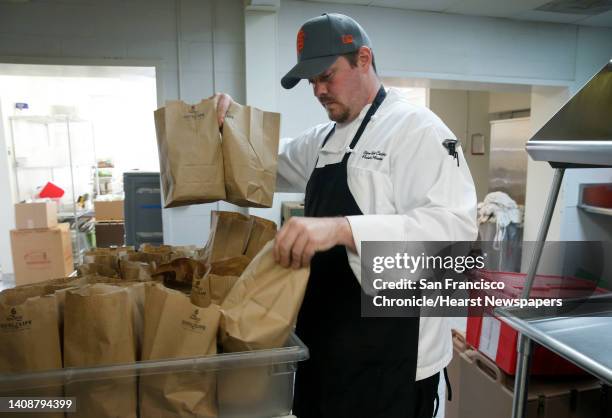 Sean Backman, a graduate of the culinary program offered by the Salvation Army, prepares lunches for firefighters in Napa, Calif. On Wednesday Oct....