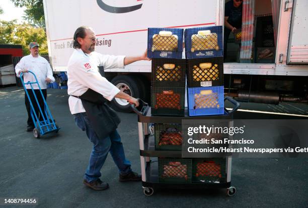 Steve Martinez and Sean Backman unload meals donated by Facebook to the Salvation Army kitchen in Napa, Calif. On Wednesday Oct. 18, 2017. Martinez...