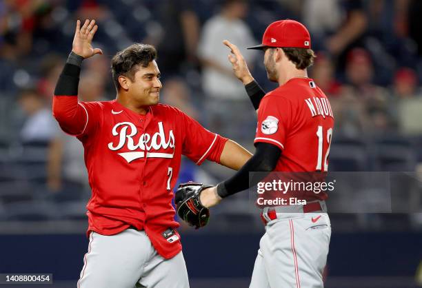 Donovan Solano of the Cincinnati Reds celebrates the win with teammate Tyler Naquin after the game against the New York Yankees at Yankee Stadium on...