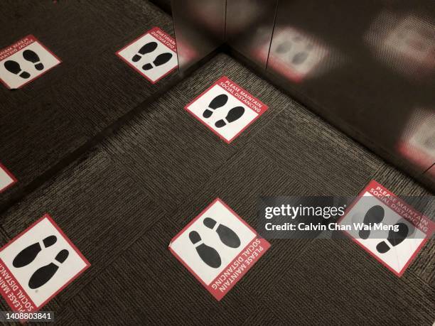 social distancing footprints stickers - social distancing elevator stock pictures, royalty-free photos & images