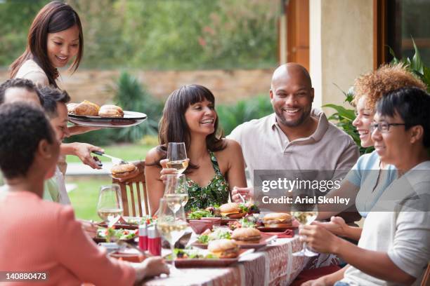 friends enjoying meal together outdoors - dia do trabalhador - fotografias e filmes do acervo