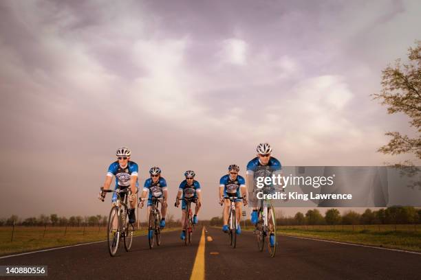 competitive bicyclists racing on remote rode - cycling team bildbanksfoton och bilder