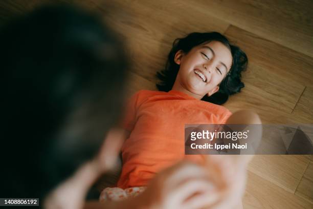 young girl having her feet tickled - tickling feet - fotografias e filmes do acervo