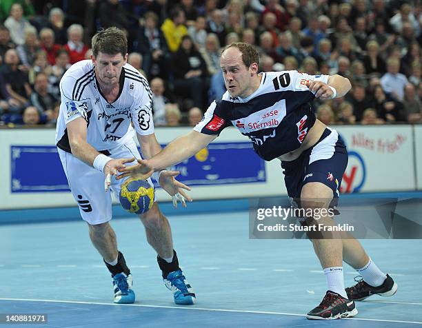 Daniel Kubes of Kiel is challenged by Roland Schlinger of Balingen during the Toyota Bundesliga match between THW Kiel and HBW Balingen-Weilstetten...