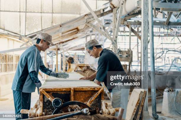 two men working in a factory - kaolin clay stock pictures, royalty-free photos & images