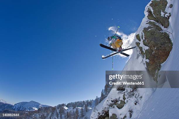 austria, tyrol, kitzbuehel, mature man doing freestyle skiing - kitzbuhel stock pictures, royalty-free photos & images