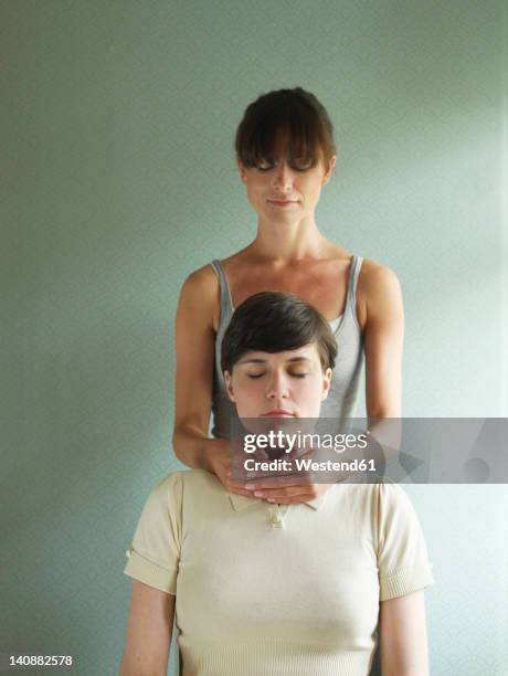 woman receiving reiki treatment from masseur - reiki fotografías e imágenes de stock