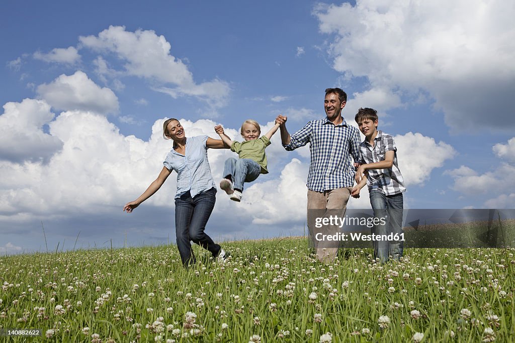 Germany, Bavaria, Altenthann, Family playing together in meadow