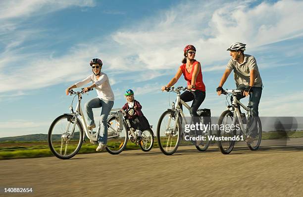 germany, bavaria, raisting, people riding electric bicycle near radio station - radrennfahrer stock-fotos und bilder