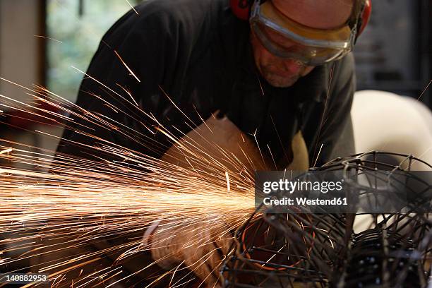 germany, upper bavaria, munich, schaeftlarn, sculptor abrasive cutting at work - sculptor stock pictures, royalty-free photos & images