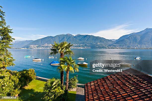 switzerland, ticino, view of roof with boats in lake maggiore - tessin stock-fotos und bilder