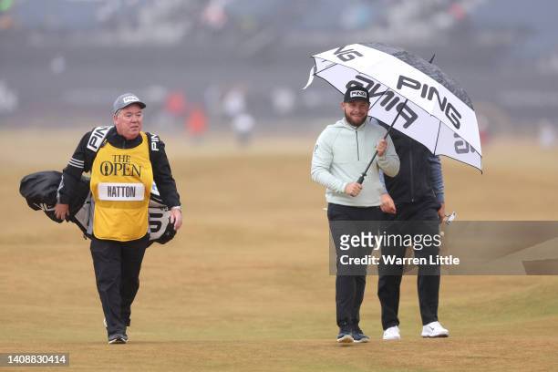 Tyrrell Hatton of England looks on alongside Caddie Mick Donaghy on the second hole during Day Two of The 150th Open at St Andrews Old Course on July...