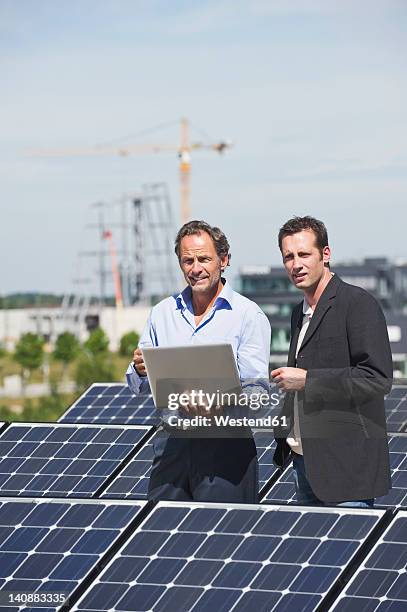 germany, munich, engineer and man discussing in solar plant - foundations conversations with suits stock-fotos und bilder