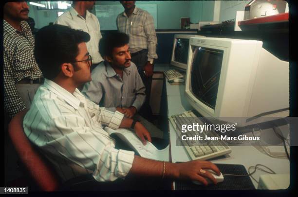 Employees at Infosys use computers in their office March 12, 1996 in Bangalore, India. Bangalore, housing over 6 million people with a thriving...