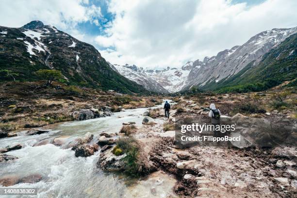 two people doing a trekking near río lasifashaj in patagonia, tierra del fuego - ushuaia stock pictures, royalty-free photos & images