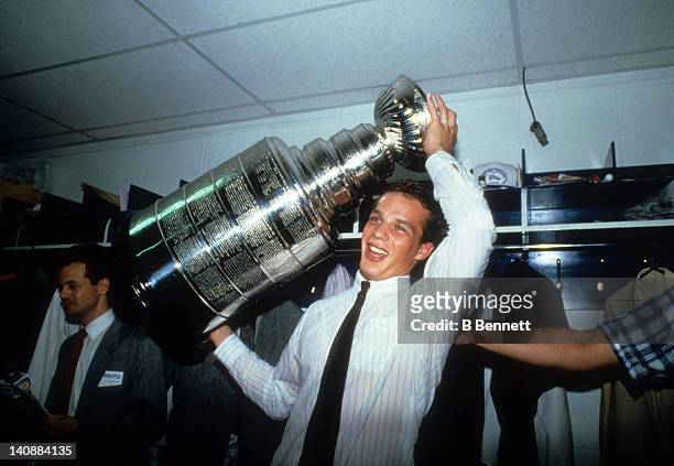 Kelly Buchberger of the Edmonton Oilers celebrates with the Stanley Cup Trophy in the locker room after the Oilers defeated the Philadelphia Flyers...