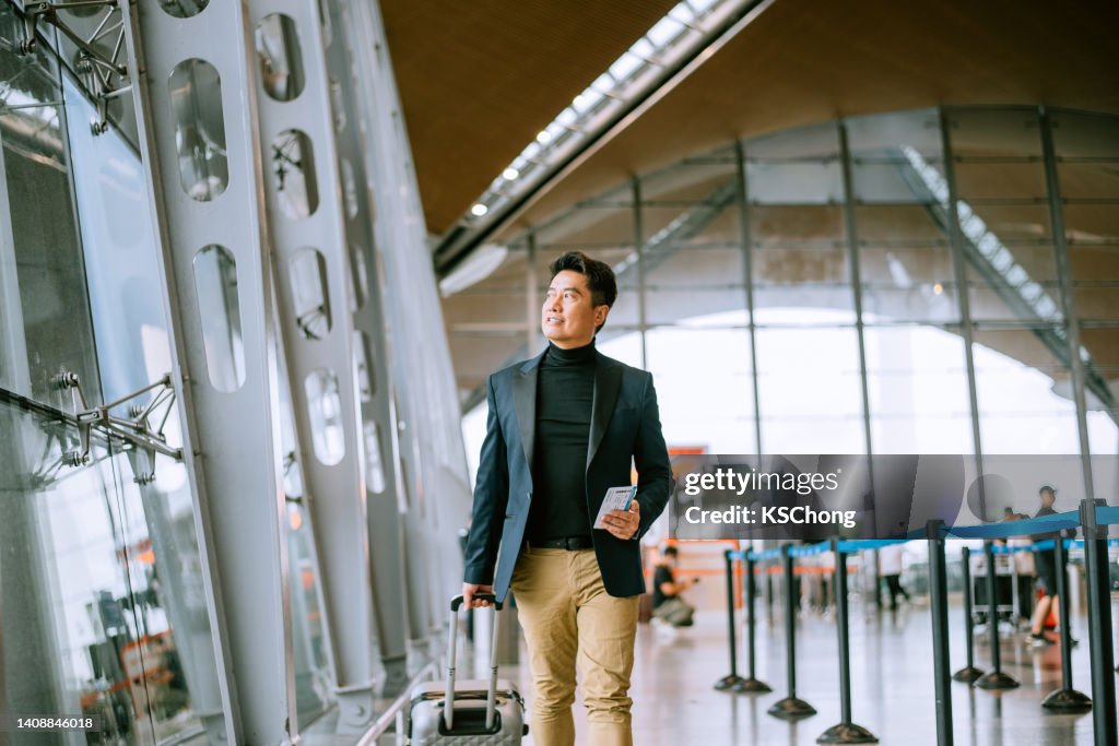 Businessman walking through airport passageway