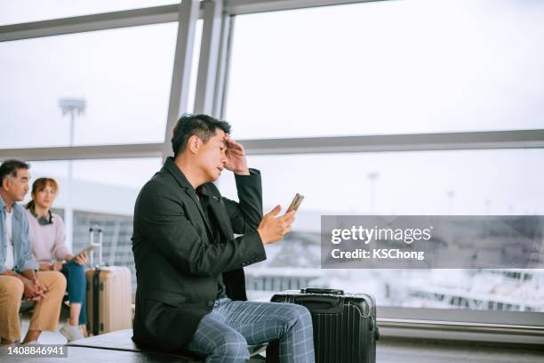 malaysia,businessman,airport,problem,bad news - cancellation stock pictures, royalty-free photos & images