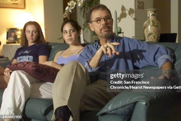 John Zank, seated far right, and his family react to Gary Condit's interview with Connie Chung in their Modesto home, on Thursday, night, August 23,...