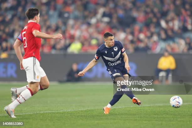 Chris Ikonomidis of the Victory scores a goal as Harry Maguire of Manchester United looks on during the Pre-Season friendly match between Melbourne...