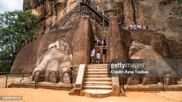 the lion's paws are near the base of the stairway that leads to the summit of lion rock. sri lanka. - sigiriya stock pictures, royalty-free photos & images