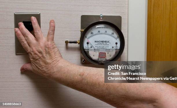 Carolyn Schjaerve, nurse manager for the SFO Medical Clinic, turns on the filter for the negative pressure room on Wednesday, November 30 which is...