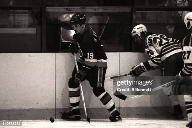 Bryan Trottier of the New York Islanders controls the puck as Dave Maloney of the New York Rangers defends during Game 3 of the 1982 Division Finals...