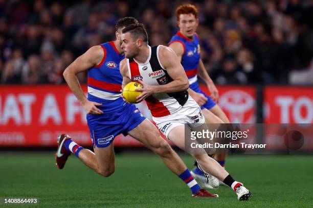 Brad Crouch of the Saints runs with the ball during the round 18 AFL match between the Western Bulldogs and the St Kilda Saints at Marvel Stadium on...