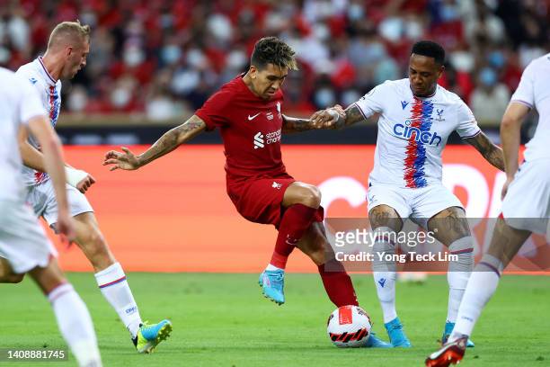 Roberto Firmino of Liverpool controls the ball against Killian Phillips and Nathaniel Clyne of Crystal Palace during the first half of their...