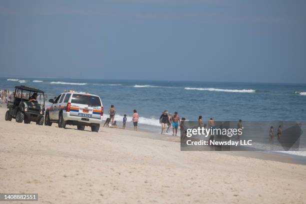 Town of Oyster Bay Constable with public safety and the Nassau County Police keep an eye on the waters off Tobay Beach for sharks on July 14, 2022 in...