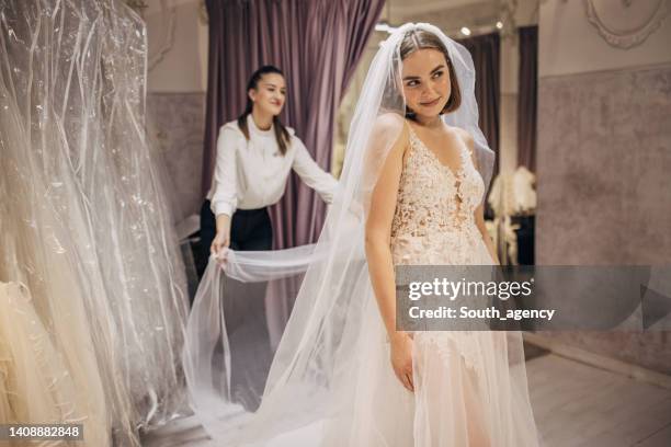 bride trying on a wedding dress - wedding dress stockfoto's en -beelden