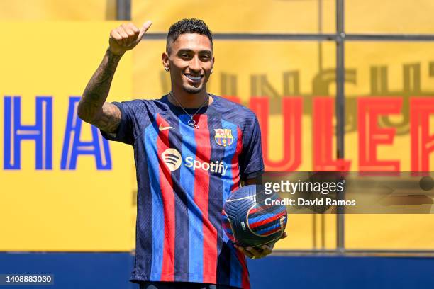 Raphael Dias Belloli 'Raphinha' poses for the media as he is presented as a FC Barcelona player at Ciutat Esportiva Joan Gamper on July 15, 2022 in...