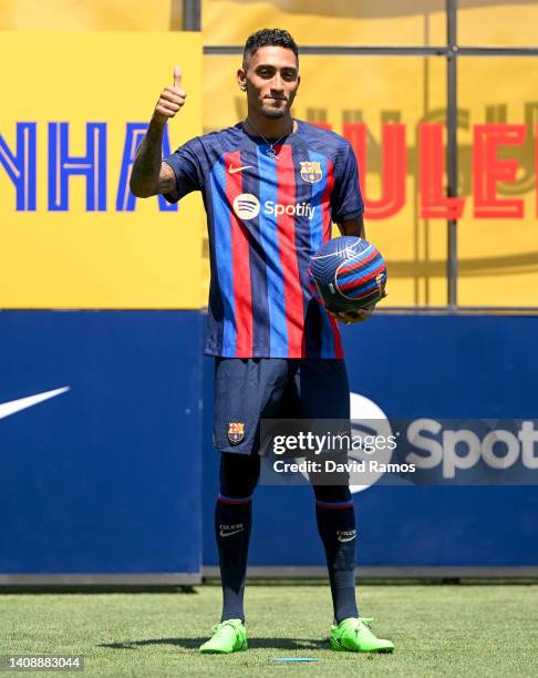 Raphael Dias Belloli 'Raphinha' poses for the media as he is presented as a FC Barcelona player at Ciutat Esportiva Joan Gamper on July 15, 2022 in...