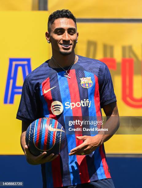 Raphael Dias Belloli 'Raphinha' poses for the media as he is presented as a FC Barcelona player at Ciutat Esportiva Joan Gamper on July 15, 2022 in...