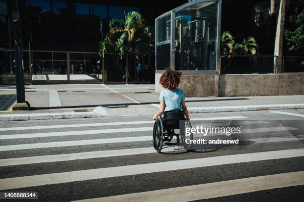 wheelchair woman crossing the street - zebra crossing stock pictures, royalty-free photos & images